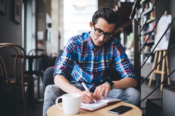 Male writer working in cafe