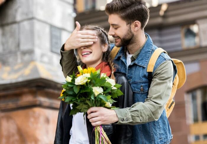 Man Surprising Woman with Flowers